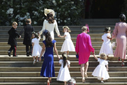 Britain's Prince George, left, Princess Charlotte, third left, Kate, the Duchess of Cambridge, background fourth left and Jessica Mulroney foreground arrive with the bridesmaids and page boys for the wedding ceremony of Prince Harry and Meghan Markle at St. George's Chapel in Windsor Castle in Windsor, near London, England, Saturday, May 19, 2018. (Jane Barlow/pool photo via AP)