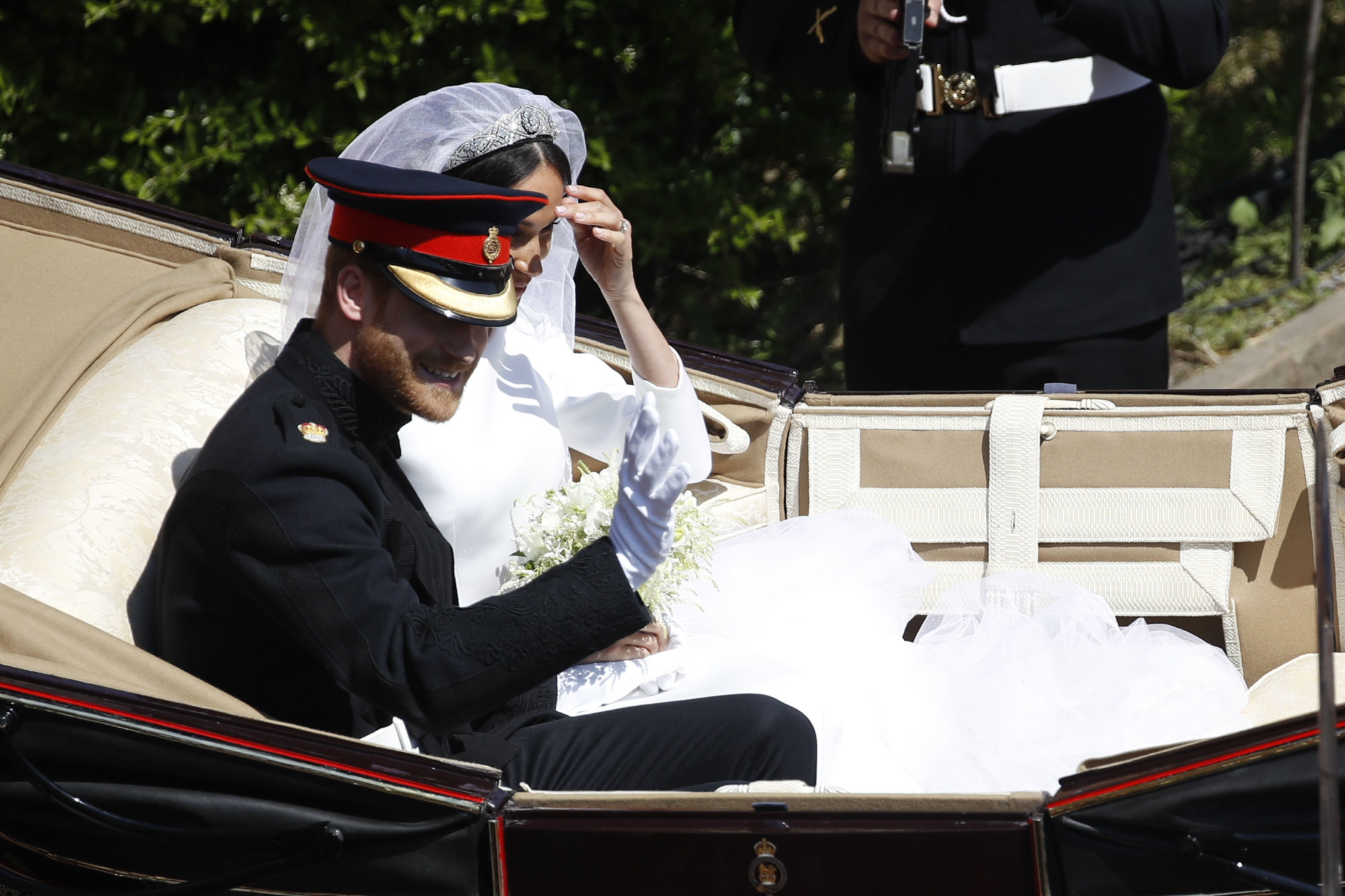 Britain's Prince Harry and Meghan Markle leave in a carriage after their wedding ceremony at St. George's Chapel in Windsor Castle in Windsor, near London, England, Saturday, May 19, 2018. (Odd Andersen/pool photo via AP)