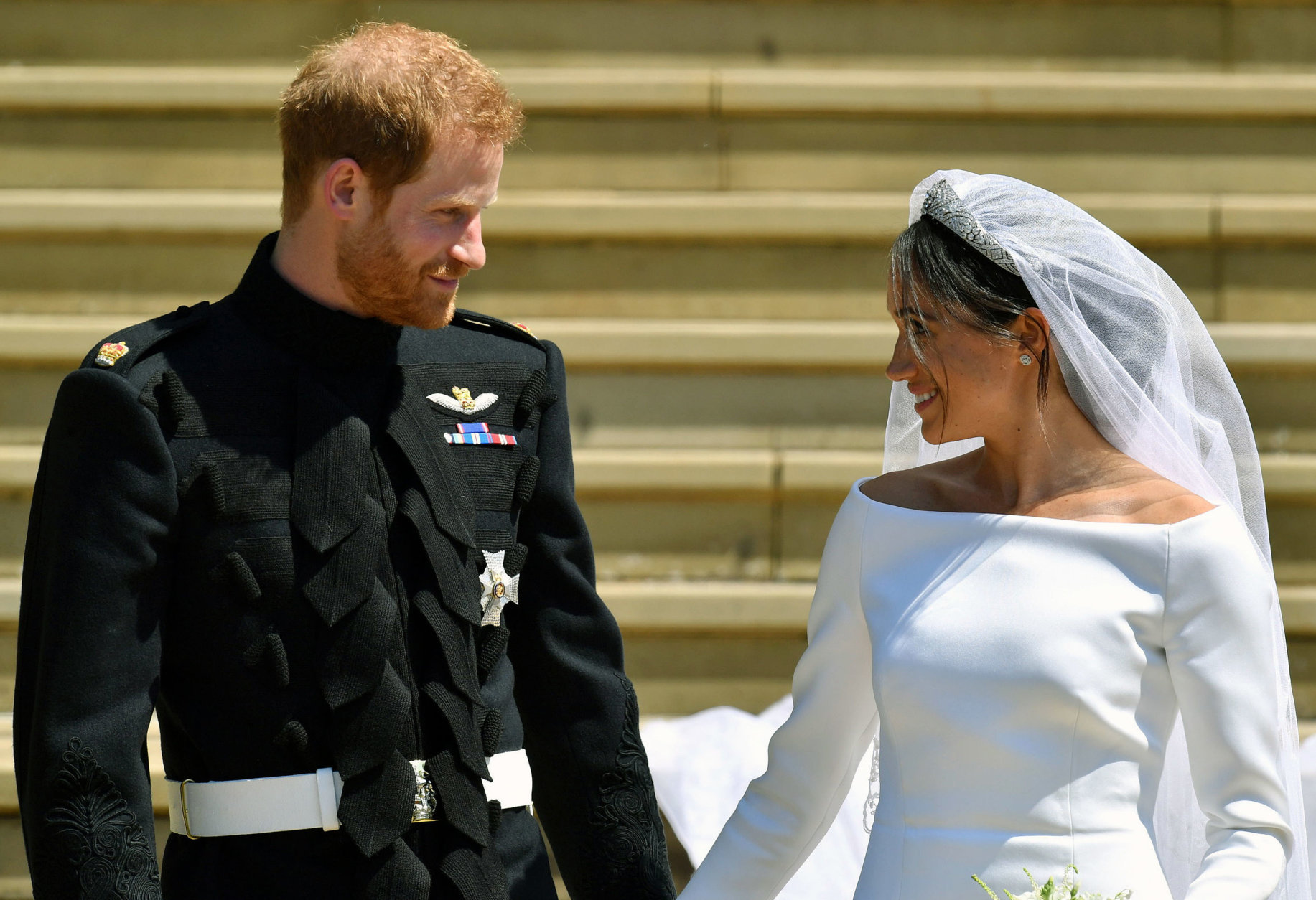 Prince Harry and Meghan Markle walk down the steps after their wedding at St. George's Chapel in Windsor Castle in Windsor, near London, England, Saturday, May 19, 2018. (Ben Birchhall/pool photo via AP)