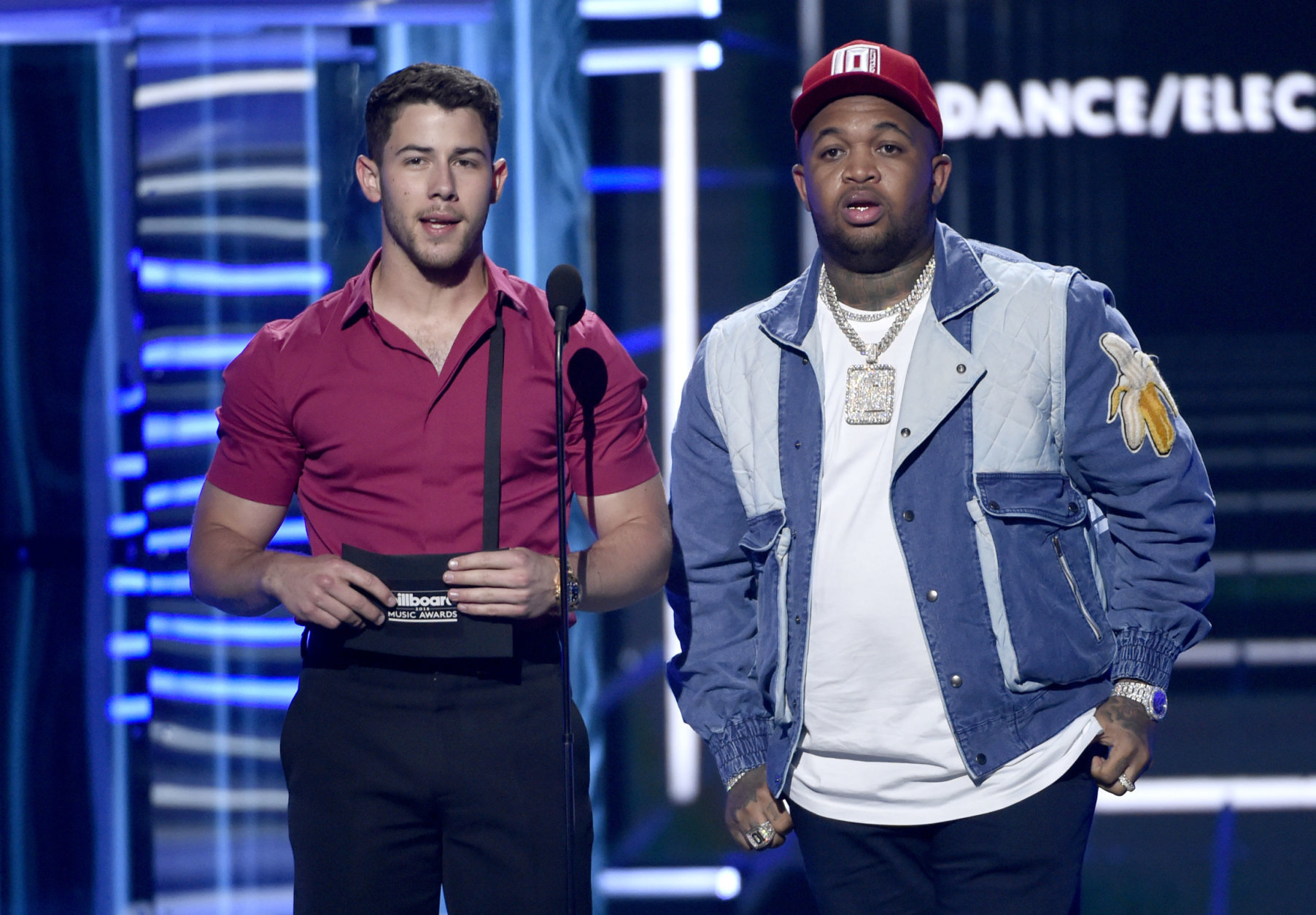 Nick Jonas, left, and Mustard present the award for top dance/electronica artist at the Billboard Music Awards at the MGM Grand Garden Arena on Sunday, May 20, 2018, in Las Vegas. (Photo by Chris Pizzello/Invision/AP)