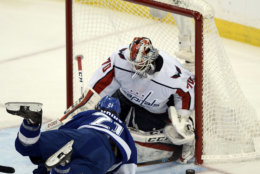 Tampa Bay Lightning center Brayden Point, left, falls in front of Washington Capitals goaltender Braden Holtby as he tries but fails to score during the second period of Game 7 of the NHL Eastern Conference finals hockey playoff series Wednesday, May 23, 2018, in Tampa, Fla. (AP Photo/Jason Behnken)