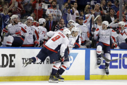 Washington Capitals, including left wing Alex Ovechkin (8). celebrate after defeating the Tampa Bay Lightning in Game 7 of the NHL Eastern Conference finals hockey playoff series Wednesday, May 23, 2018, in Tampa, Fla. (AP Photo/Chris O'Meara)