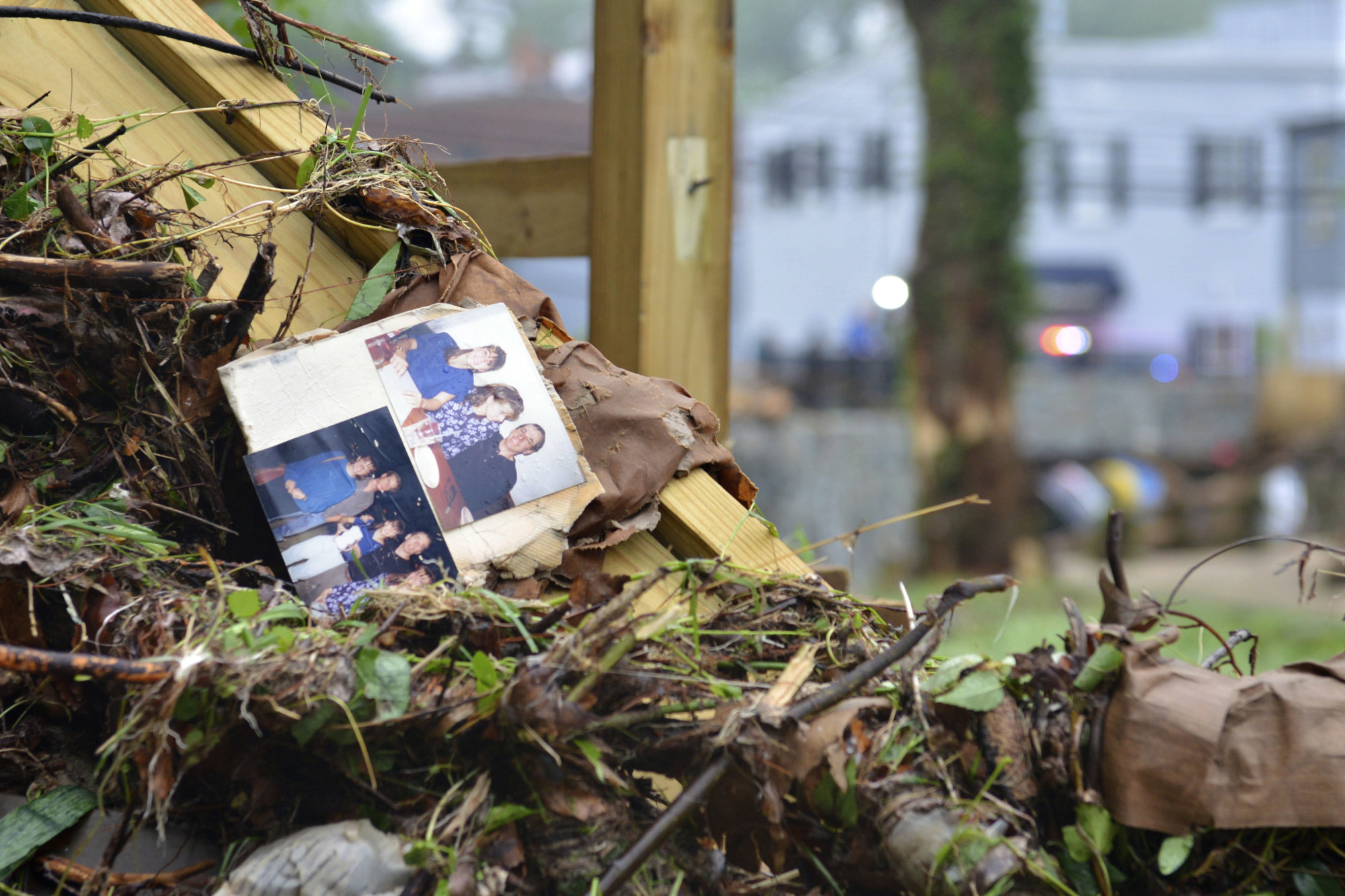 Family photos rest among debris after flash flooding in Ellicott City, Md., Monday, May 28, 2018. Sunday's destructive flooding left the former mill town heartbroken as it had bounded back from another destructive storm less than two years ago. (AP Photo/David McFadden)