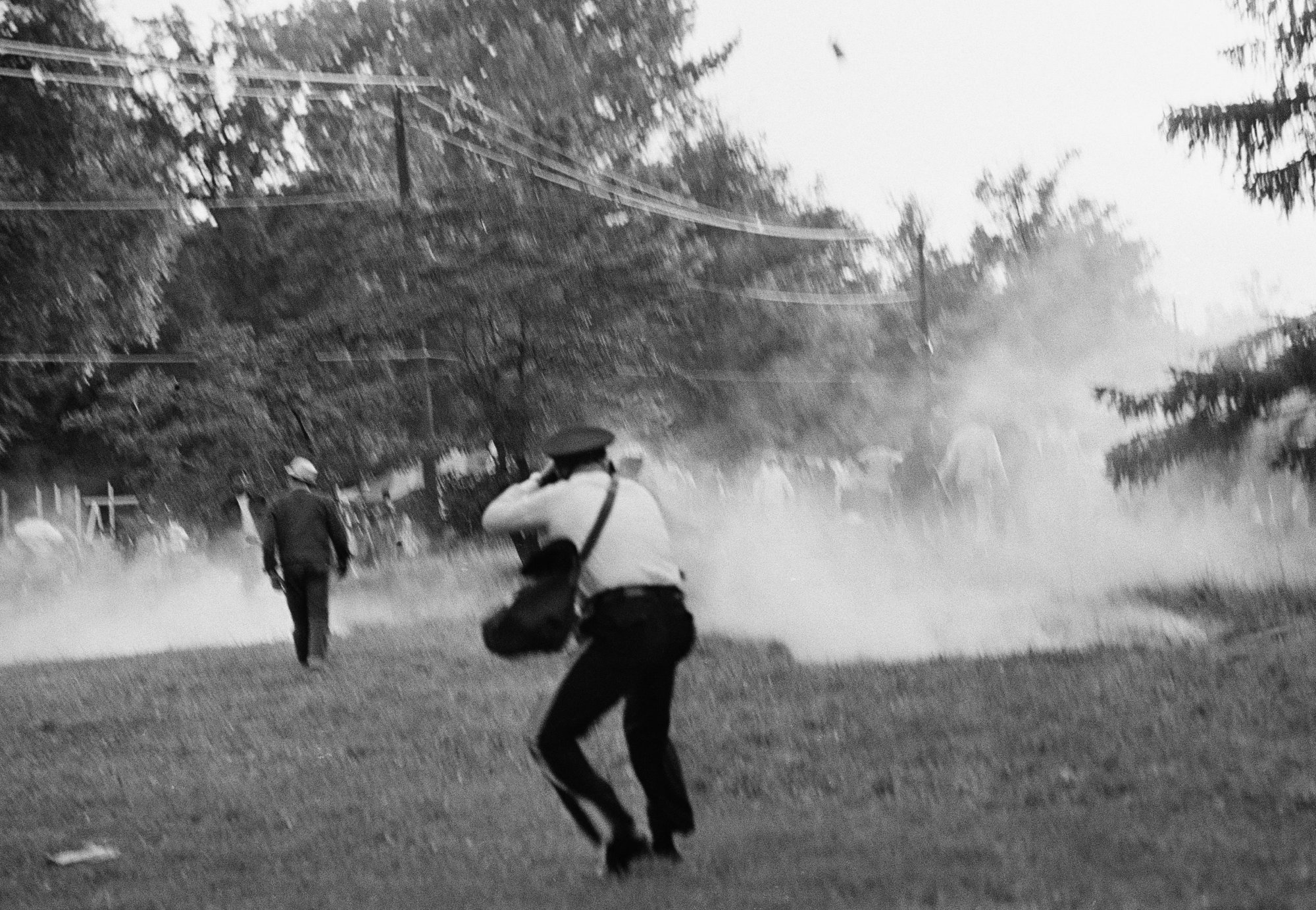 Poor People's demonstrators run from tear gas used by police late on June 20, 1968 in Washington, near the campaign's  "Resurrection City" encampment.    Witnesses reported the  group became unruly when returning to the encampment from a demonstration at the Department of Agriculture. (AP Photo/Charles Harrity)