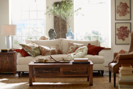 This photo provided by Pottery Barn shows a reclaimed wood coffee table in a living room that is part of the new Bowry collection. Each piece is made of reclaimed wood, which is an increasingly popular material for furniture. (Pottery Barn via AP)