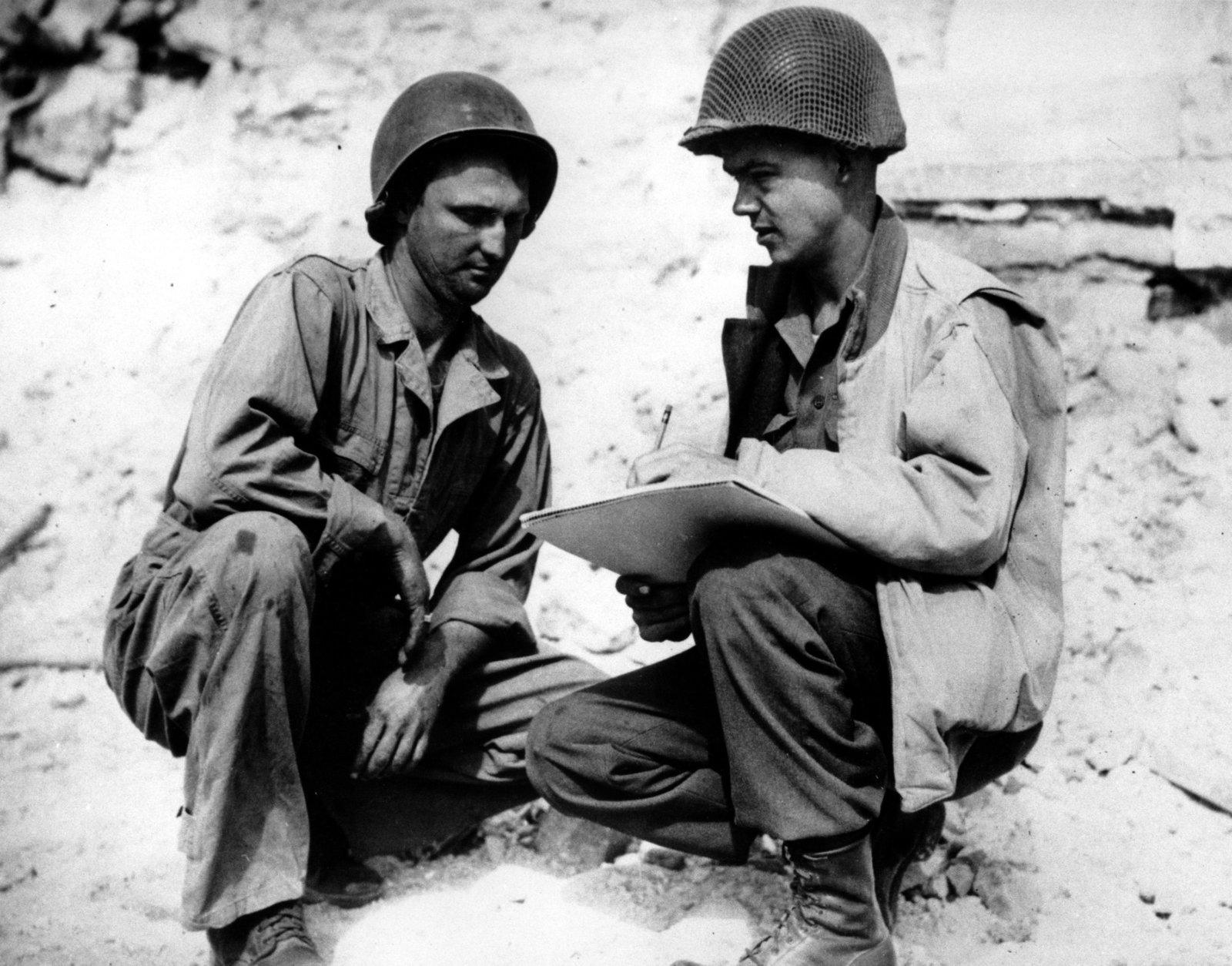Pvt. Robert L. Bowman, left, of Hogansville, Ga., poses for Stars and Stripes artist Sgt. Bill Mauldin, on the Anzio beachhead in Italy during World War II in May, 1944.  The completed picture will be known as "G.I. Joe."  (AP Photo)