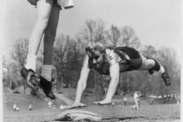 Photograph shows Linda McConkey, of the Lorelei Ladies softball team, diving for third base during an exhibition game; also shows the legs of Jerrie Rainey, playing third base for the Atlanta Tomboys, as she jumps for the ball in Atlanta, Georgia. (Courtesy: Library of Congress)