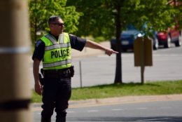 Arlington County Police stop drivers who appeared to fail to yield to an undercover officer in a crosswalk on Fairfax Drive. (WTOP/Dave Dildine)