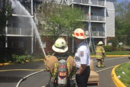 Fire crews work to extinguish the fire in the 14400 block of Woodmere Court in Centreville Wednesday afternoon. (Courtesy Fairfax County Fire and Rescue)