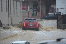 A red vehicle abandoned in floodwaters