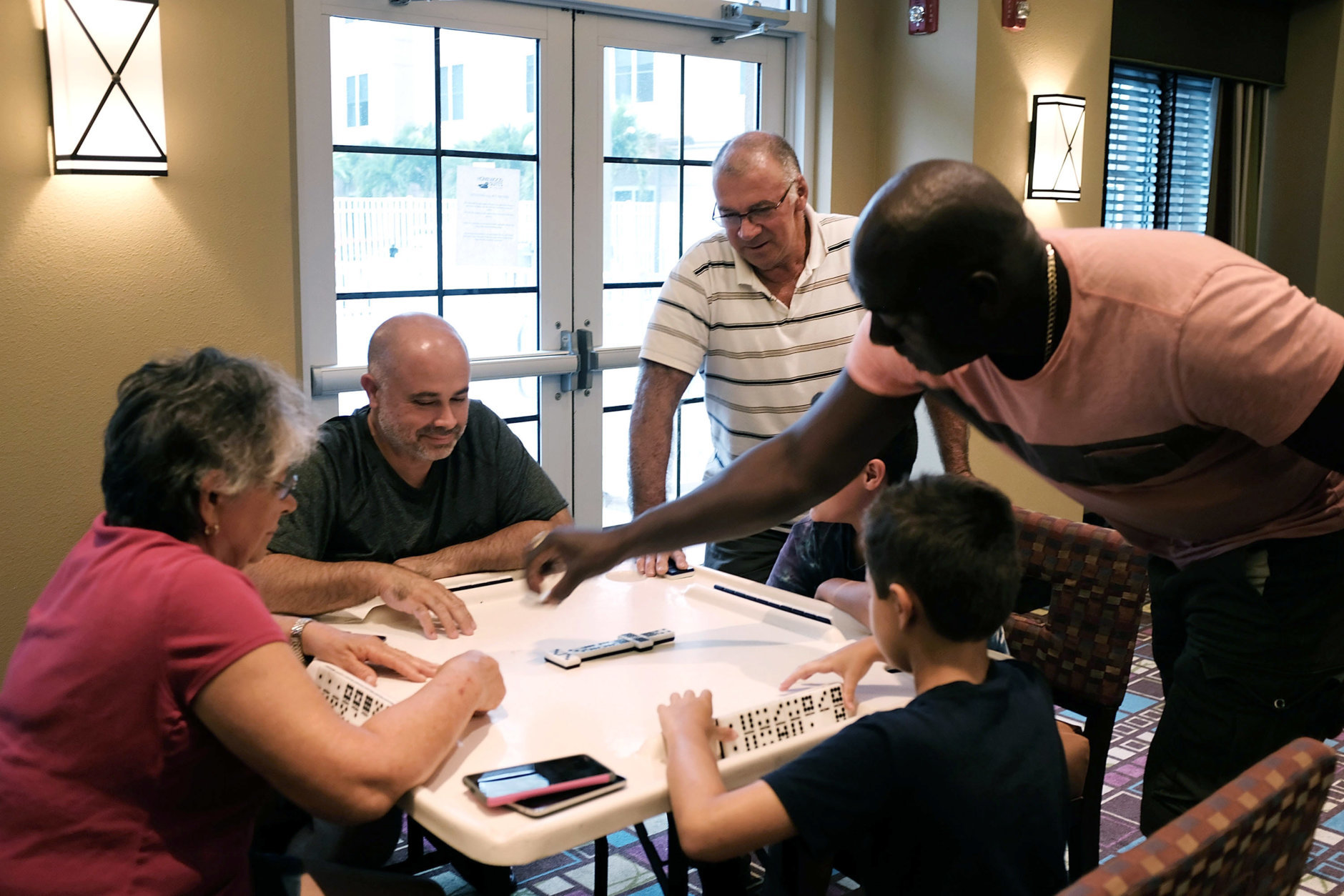 FORT MYERS, FL - SEPTEMBER 10: A family plays dominoes in a hotel as Hurricane Irma arrives into southwest Florida  on September 10, 2017 in Fort Myers, Florida. With businesses closed, thousands in shelters and a mandatory evacuation in coastal communities, the Fort Myers area is preparing for a possibly catastrophic storm.  (Photo by Spencer Platt/Getty Images)