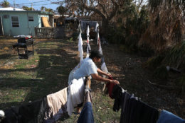 MARATHON, FL - SEPTEMBER 19:  Patricia Spencer hangs up laundry as she tries to salvage what she can from her home after it was damaged by hurricane Irma on September 19, 2017 in Marathon, Florida.  The process of rebuilding has begun as the Federal Emergency Management Agency has reported that 25-percent of all homes in the Florida Keys were destroyed and 65-percent sustained major damage when they took a direct hit from Hurricane Irma.  (Photo by Joe Raedle/Getty Images)