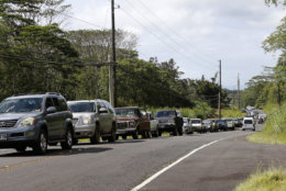 Residents of the Leilani Estates queue in a line to enter the subdivision to gather possessions from their homes, Sunday, May 6, 2018, in Pahoa, Hawaii. Scientists reported lava spewing more than 200 feet (61 meters) into the air in Hawaii's recent Kilauea volcanic eruption, and some of the more than 1,700 people who evacuated prepared for the possibility they may not return for quite some time. (AP Photo/Marco Garcia)