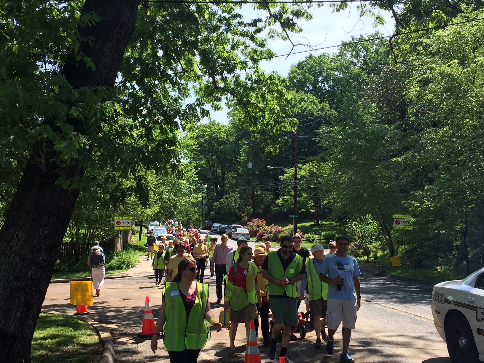 “As you can see we don’t have any traffic calming, we don’t have any sidewalks, no bike lane, and there were 11 crashes on this one mile section of road last year,” says Corinne Hart, who helped organize a safety walk attended by around 100 residents and politicians Sunday. (WTOP/John Domen) 