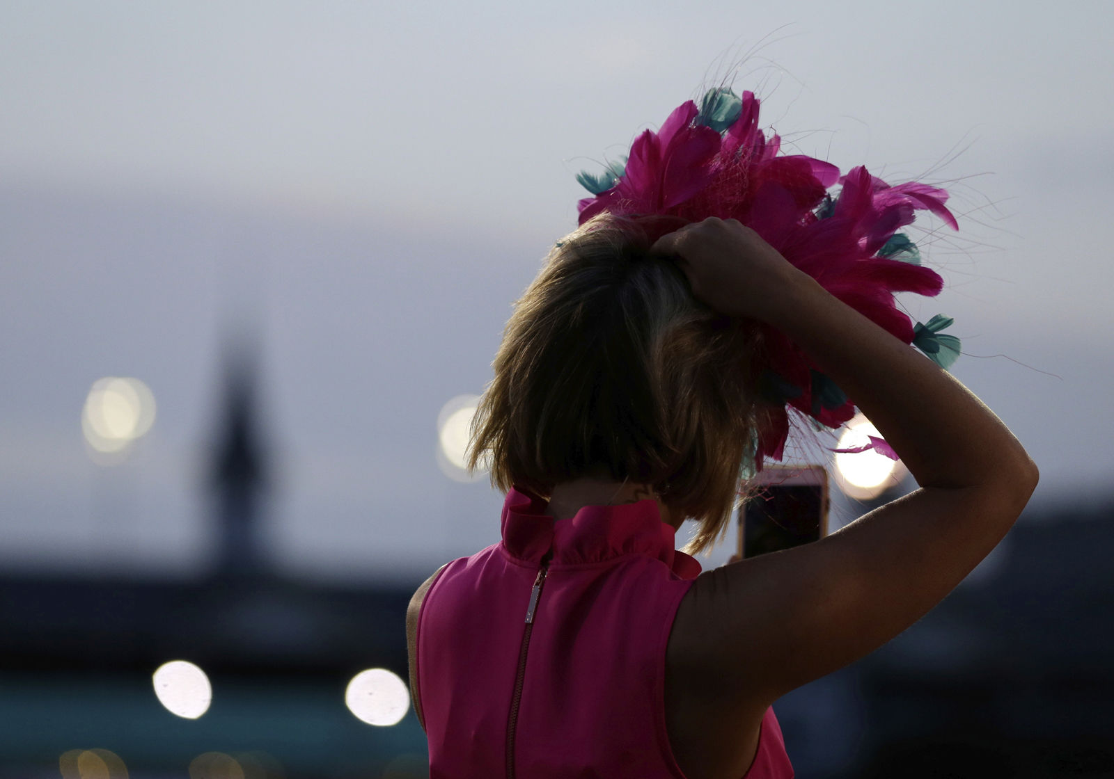A tv reporter watches during the morning workouts for 144the running of the Kentucky Derby horse race at Churchill Downs Friday, May 4, 2018, in Louisville, Ky. (AP Photo/Kiichiro Sato)