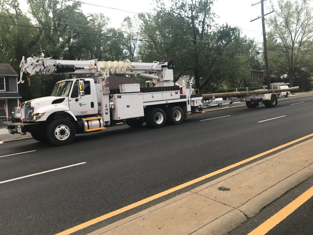 Replacement poles arrived on New Hampshire Avenue in Langley Park a little after 6 a.m. on Friday, however it might be a few hours before traffic completely re-opens. (WTOP/Neal Augenstein)