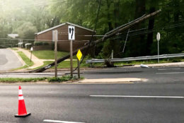 A damaged power pole along New Hampshire Avenue in Langley Park, Maryland. (WTOP/Neal Augenstein)