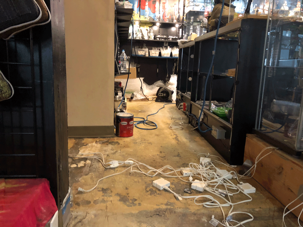 Cleanup begins inside the Peace of Sunshine shop on Frederick Road in Catonsville, Maryland, after severe flooding hit the area on May 27, 2018. (Melissa Howell/WTOP).