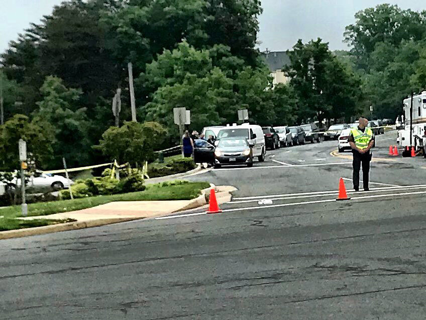 Investigators examine a car, which the person of interest was driving when they were stopped by Loudoun County Deputies. (WTOP/Neal Augenstein)