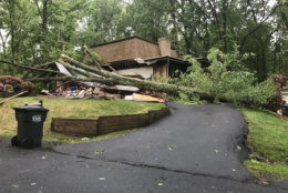 A downed tree caused a lot of damage for this home on Pinoak Lane in Reston, Virginia. (WTOP/Neal Augenstein)