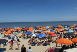 People are seen sunning on Bethany Beach