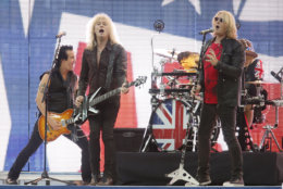 FILE - In this Sept. 28, 2014, file photo, Def Leppard performs before an NFL football game between the Miami Dolphins and the Oakland Raiders, at Wembley Stadium in London. Def Leppard will be the first artist to debut a new music video through the "Guitar Hero" video game. (AP Photo/Lefteris Pitarakis, File)