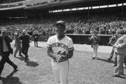 Homerun king, Henry Aaron grins as a near record crowd gives him a standing ovation during opening day ceremonies before American League game against the Cleveland Indians at Milwaukee Stadium, Friday, April 11, 1975. More than 48,000 persons turned out to see Aaron and the Brewers at the season opener. (AP Photo/Paul Shane)