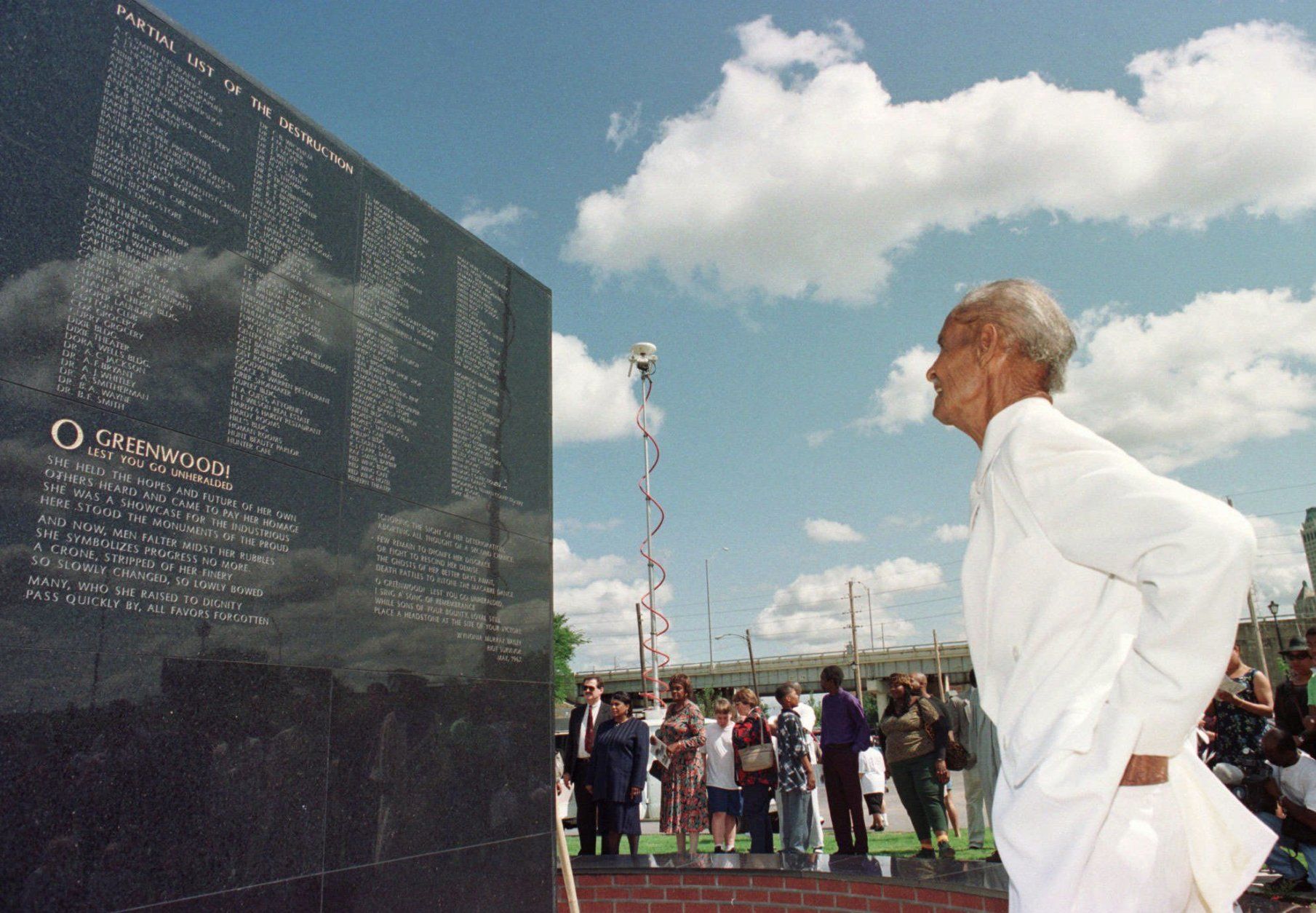 Tulsa race riot survivor George Monroe, now 82 years old, examines the monument dedicated Saturday, June 1, 1996, as part of the 75th anniversary commemoration ceremonies in Tulsa, Okla. Saturday marks the first time the City of Tulsa has officially recognized the events of the riot that took place on this day in 1921. (AP Photo by Michael Wyke)