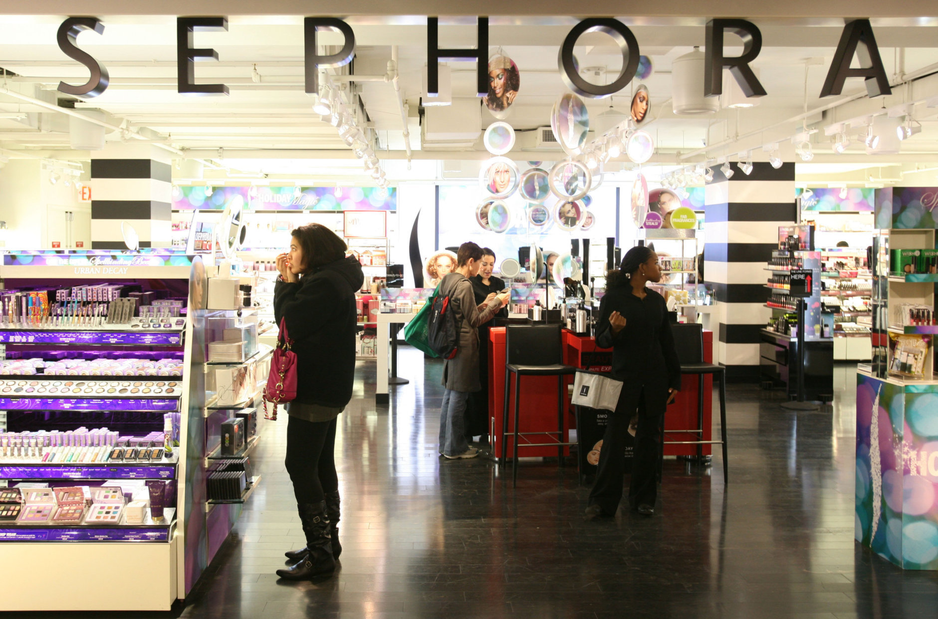 In this Friday, Oct. 23, 2009 photo, shoppers  visit a Sephora boutique inside a J.C. Penney store in New York. (AP Photo/Mark Lennihan)