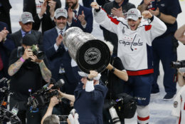 Washington Capitals head coach Barry Trotz holds up the Stanley Cup after the Capitals defeated the Vegas Golden Knights in Game 5 of the NHL hockey Stanley Cup Finals Thursday, June 7, 2018, in Las Vegas. (AP Photo/Ross D. Franklin)
