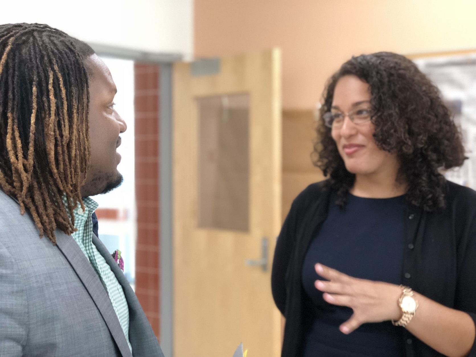Marqwan Jermaine Sirls will teach English at Bowie High School. He chats with Mary Perez who will be teaching Spanish at Benjamin Tasker Middle School. (WTOP/Kate Ryan)