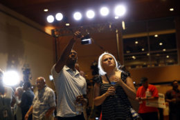 Dallas Matthews, left, and Tabitha Jackson, supporters of Maryland Democratic gubernatorial candidate Ben Jealous, watch voting results during an election night party, Tuesday, June 26, 2018, in Baltimore. Jealous and Prince George's County Executive Rushern Baker lead a crowded Democratic primary field to win a nomination to face popular Republican Gov. Larry Hogan in the fall. (AP Photo/Patrick Semansky)