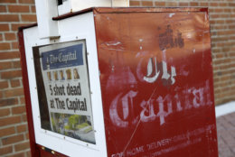 A Capital Gazette newspaper rack displays the day's front page, Friday, June 29, 2018, in Annapolis, Md. A man armed with smoke grenades and a shotgun attacked journalists in the newspaper's building Thursday, killing several people before police quickly stormed the building and arrested him, police and witnesses said. (AP Photo/Patrick Semansky)