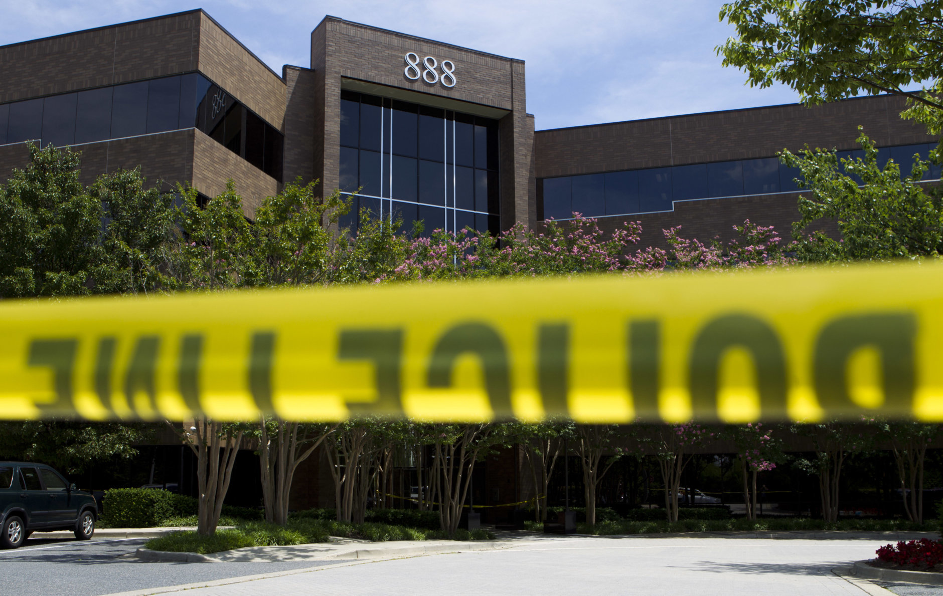 Police tape surrounds the front entrance of the office building housing The Capital Gazette newspaper in Annapolis, Md., on Friday, June 29, 2018. A man armed with smoke grenades and a shotgun attacked journalists in the building Thursday, killing several people before police quickly stormed the building and arrested him, police and witnesses said. (AP Photo/Jose Luis Magana)