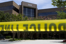 Police tape surrounds the front entrance of the office building housing The Capital Gazette newspaper in Annapolis, Md., on Friday, June 29, 2018. A man armed with smoke grenades and a shotgun attacked journalists in the building Thursday, killing several people before police quickly stormed the building and arrested him, police and witnesses said. (AP Photo/Jose Luis Magana)