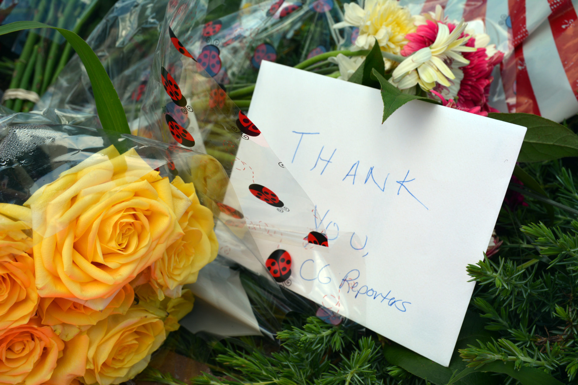 Flowers and a note placed near the site of a shooting at the Capital Gazette in Annapolis Maryland. On Friday night, area clergy held a prayer vigil at the Westfield Annapolis Mall. (Courtesy/Bethany Swain)