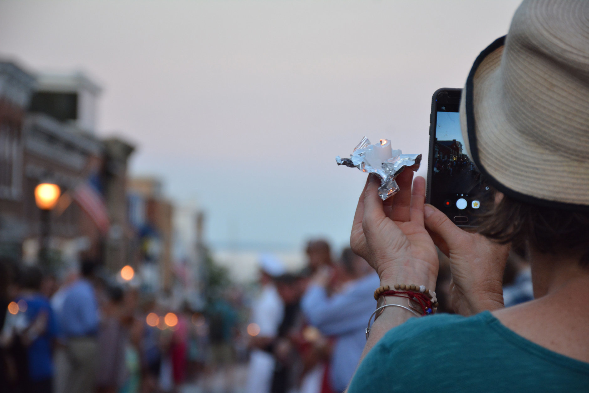 An onlooker takes a photo on their smartphone during a Friday vigil in downtown Annapolis for victims killed in a shooting at the Capital Gazette in Annapolis, Maryland. (Courtesy/Bethany Swain)