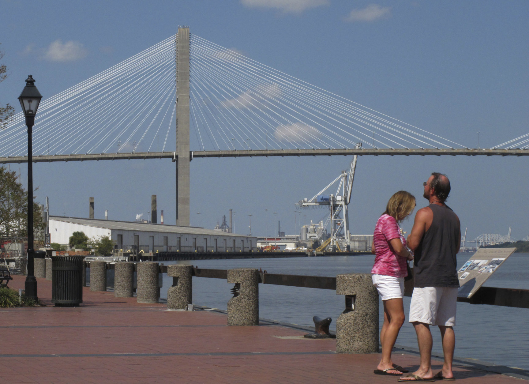 FILE - This Sept. 28, 2017 file photo shows the Eugene Talmadge Memorial Bridge over the Savannah river, in Savannah, Ga.  The Girl Scouts have hired a lobbyist, met with the governor and made plans for a milk-and-cookies reception for Georgia lawmakers as they try to get a Savannah bridge renamed for Girl Scouts founder Juliette Gordon Low.  Sue Else of the Girls Scouts of Historic Georgia says up to 300 scouts will visit the state Capitol in February 2018 to meet with lawmakers about the bridge.   (AP Photo/Russ Bynum)