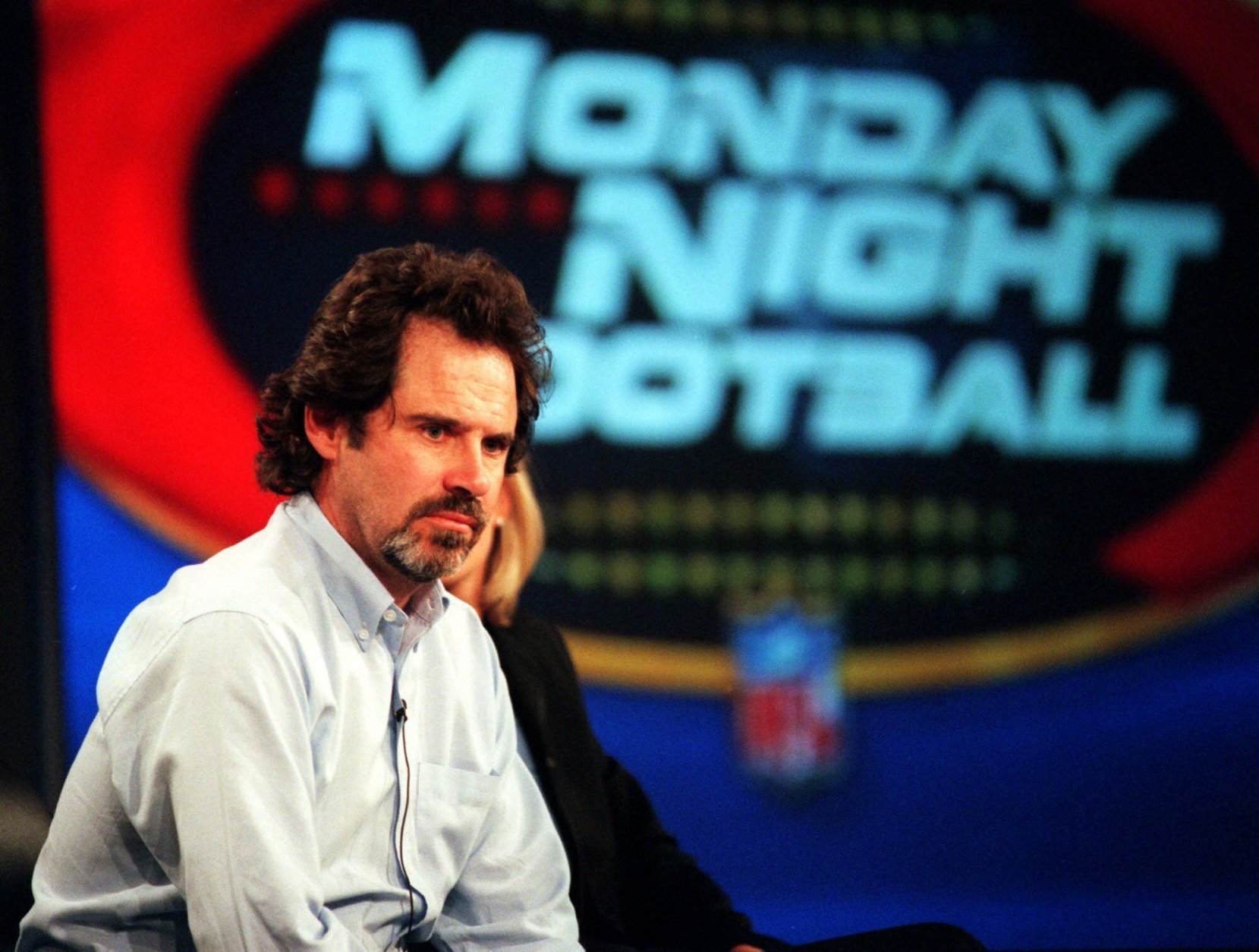 Comedian Dennis Miller, a new addition to the announcing team of ABC's "Monday Night Football," considers a reporter's question during a news conference at the ABC 2000 Summer Press Tour in Pasadena, Calif., Sunday, July 16, 2000. (AP Photo/Chris Pizzello)
