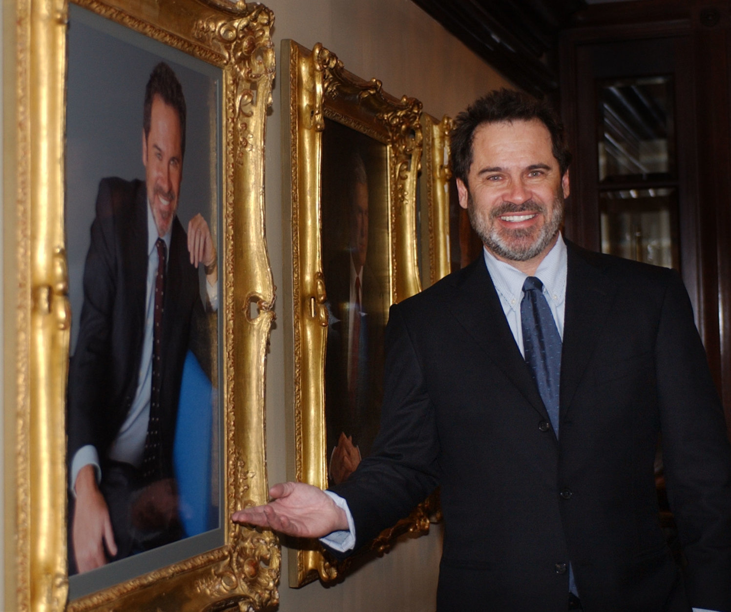 ** ADVACNE FOR MONDAY, JAN 26 ** Dennis Miller poses in front of a portrait of himself hanging in the lobby of the Occidental Restaurant in Washington,  Jan. 21, 2004.  Miller is a familiar figure from his years on "Saturday Night Live," HBO and "Monday Night Football," but he will be in a different role on his topical CNBC talk show, which debuts Monday, Jan. 26, 2004 at 9 p.m. EST. (AP Photo/Susan Walsh)