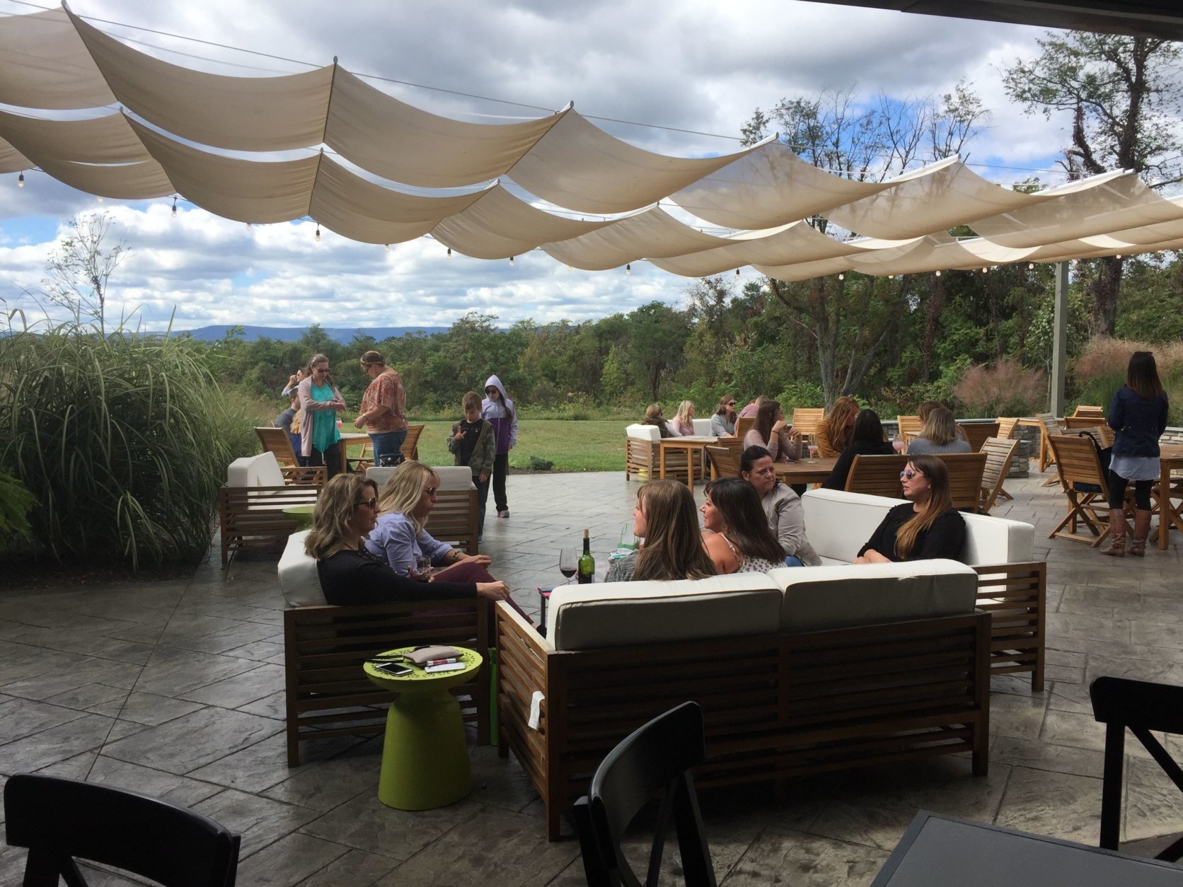 This Sept. 30, 2017 photo shows wine tasters relaxing on the patio at the James Charles Winery &amp; Vineyard in Winchester, Va. Thomas Jefferson may have been Virginia's first winemaker but it took another 200 years for the industry to blossom in the state. Today with 300 wineries, Virginia is the country's fifth-largest wine region. (AP Photo/Sally Carpenter Hale)