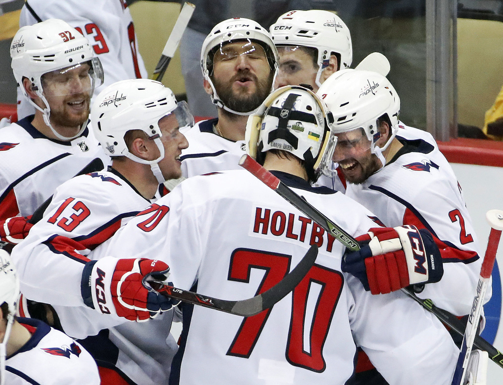 Washington Capitals goaltender Braden Holtby (70) joins the celebration of with Evgeny Kuznetsov (92), Jakub Vrana (13), Alex Ovechkin, top center, and Matt Niskanen (2) Kuznetsovs' game-winning goal during the overtime period in Game 6 of an NHL second-round hockey playoff series against the Pittsburgh Penguins in Pittsburgh, Monday, May 7, 2018. The Capitals won the game 2-1 to take the series, four games to two. AP Photo/Gene J. Puskar)