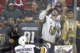 Vegas Golden Knights forward Jonathan Marchessault tosses a puck over the glass to fans as the team warms up before Game 4 of the NHL hockey Stanley Cup Final against the Washington Capitals, Monday, June 4, 2018, in Washington. (AP Photo/Pablo Martinez Monsivais)