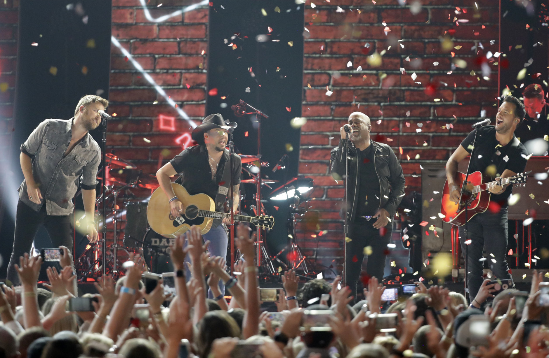 Charles Kelley, from left, Jason Aldean, Darius Rucker, and Luke Bryan perform "Straight To Hell" at the CMT Music Awards at the Bridgestone Arena on Wednesday, June 6, 2018, in Nashville, Tenn. (AP Photo/Mark Humphrey)