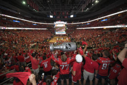 Fans react at a viewing party for Game 5 of the NHL hockey Stanley Cup Final between the Washington Capitals and the Vegas Golden Knights, Thursday, June 7, 2018, in Washington. (AP Photo/Nick Wass)
