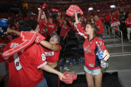 Fans celebrate during a viewing party for Game 5 of the NHL hockey Stanley Cup Final between the Washington Capitals and the Vegas Golden Knights, Thursday, June 7, 2018, in Washington. (AP Photo/Nick Wass)