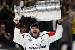 Washington Capitals left wing Alex Ovechkin, of Russia, hoists the Stanley Cup after the Capitals defeated the Golden Knights in Game 5 of the NHL hockey Stanley Cup Finals Thursday, June 7, 2018, in Las Vegas. (AP Photo/John Locher)
