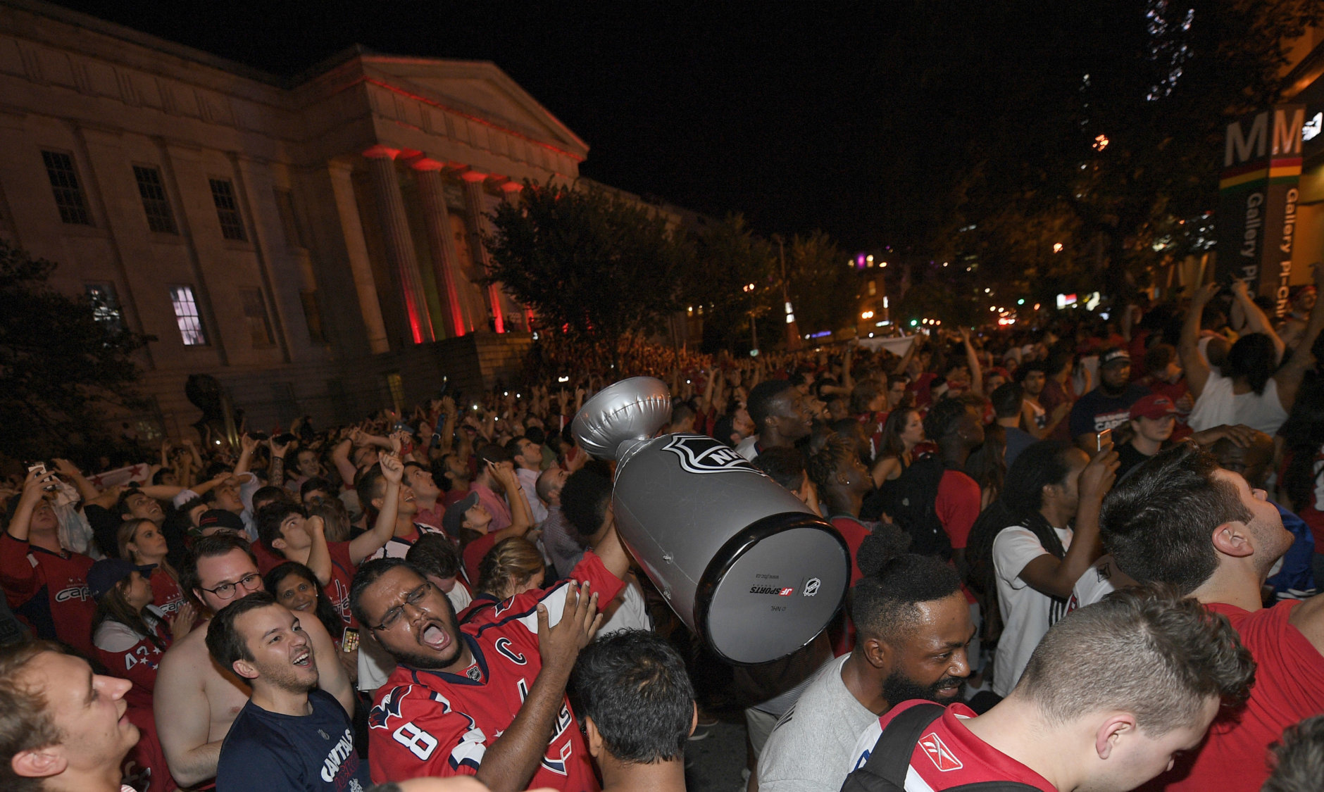 Washington Capitals fans celebrate in the streets outside Capital One Arena after Game 5 of the NHL hockey Stanley Cup Final between the Washington Capitals and the Vegas Golden Knights in Las Vegas, Thursday, June 7, 2018, in Washington. The Capitals won the Stanley Cup with a 4-3 win Thursday night. (AP Photo/Nick Wass)