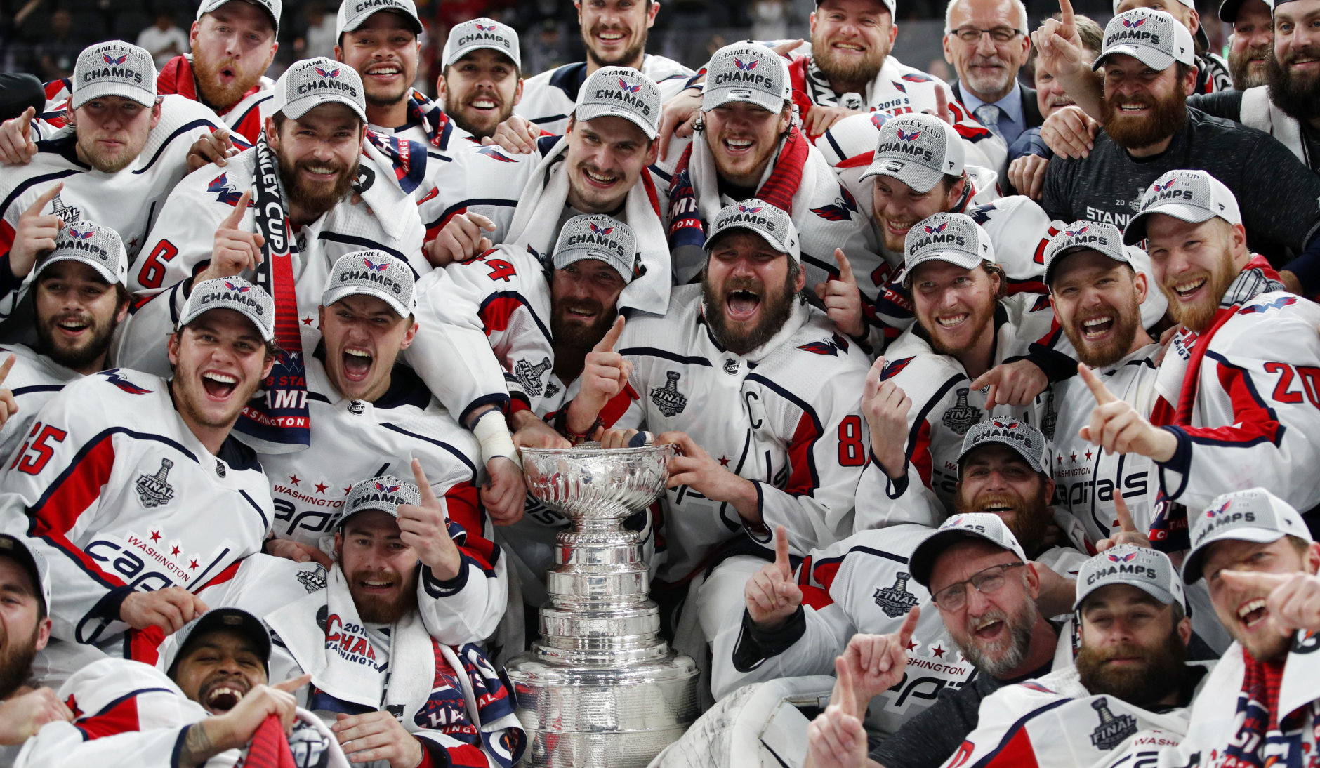 Members of the Washington Capitals pose with the Stanley Cup after the Capitals defeated the Golden Knights 4-3 in Game 5 of the NHL hockey Stanley Cup Finals Thursday, June 7, 2018, in Las Vegas. (AP Photo/John Locher)