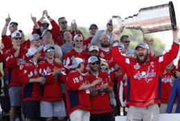 Washington Capitals Alex Ovechkin, from Russia, right, holds up the Stanley Cup during a victory rally for the Washington Capitals in celebration of winning the Stanley Cup, Tuesday, June 12, 2018, on the National Mall in Washington. (AP Photo/Jacquelyn Martin)